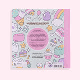 Back cover of the Coloring Cuteness: A Pusheen Coloring & Activity Book. The mint-colored background has a pattern of pastel graphics of Pusheen climbing an ice cream cone, Pusheen as a ghost, Pusheen as a strawberry milk carton, a teapot, candy, and more. The book has a light pink spine and contains a description of activities and coloring pages you’ll find inside the book. Print on the bottom of the cover is the publisher, a UPC code, and pricing information.
