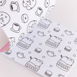 Pusheen Coloring & Activity Book is opened to two white coloring pages with black graphics. On the left page is a repeating pattern of Pusheen as a donut surrounded by cups of coffee and smaller glazed donuts. On the righthand page is a repeating pattern of Pusheen the Cat sitting atop a macaron surrounded by polka dots, tea pots, and smaller macarons.  