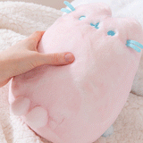 Model strokes Pink Dreamsheen Plush's fabric to show the super soft texture of the Pusheen Plush.