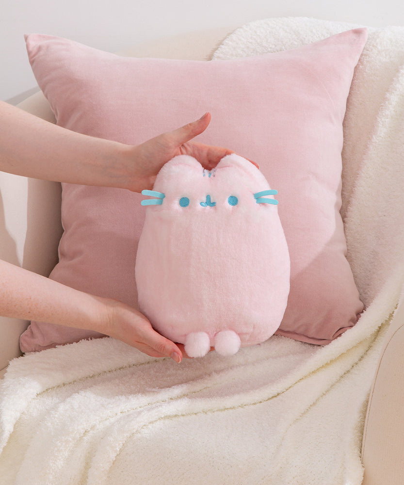 Model holding a Pink Dreamsheen Plush toy to show size and scale of plushie.
