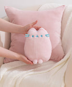 Model holding a Pink Dreamsheen Plush toy to show size and scale of plushie.