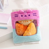 Gamer Pusheen Bag of Chips Plush sits on a white desktop. The plush bag with see-through window holds three triangle plush chips that mimic tortilla chips.