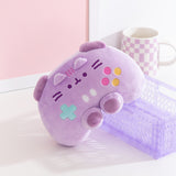 Purple Gamer Pusheen plush is propped up on a desk to show its unique shape. Pusheen the Cat's ears can be seen extending off the front of the plush. 