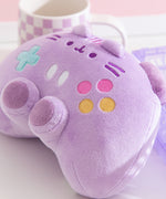 Close-up of the pink, yellow, white, and teal buttons embroidery detail on the front of the controller shaped plush.