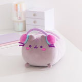 Front view of the Gamer Pusheen Log Squisheen Plush. The long cat plush toy wears a set of purple, pink, and teal headphones that extend over the top of her head.