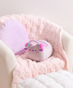 Gamer Pusheen Log Squisheen Plush sits in a chair surrounded by a pillow and blanket to show the size and scale of the oversized plush.