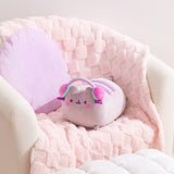 Gamer Pusheen Log Squisheen Plush sits in a chair surrounded by a pillow and blanket to show the size and scale of the oversized plush.