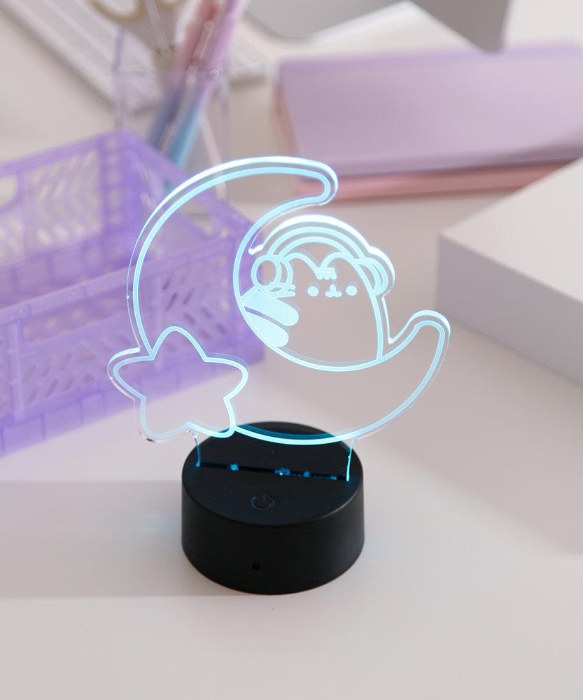 Pink LED light shaped with a crescent moon, star, and Pusheen the Cat wearing headphones.