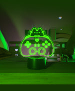 Green LED night light shaped like a gaming controller on a dark background