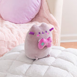 Side quarter view of the Gamer Pusheen Plush. The gray cat has a pink embroidered blush that sits under her purple eyes and mouth.
