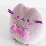 Close-up of the Gamer Pusheen Plush toy. The purple-hued cat has purple whiskers that extend off the front side of the plush.