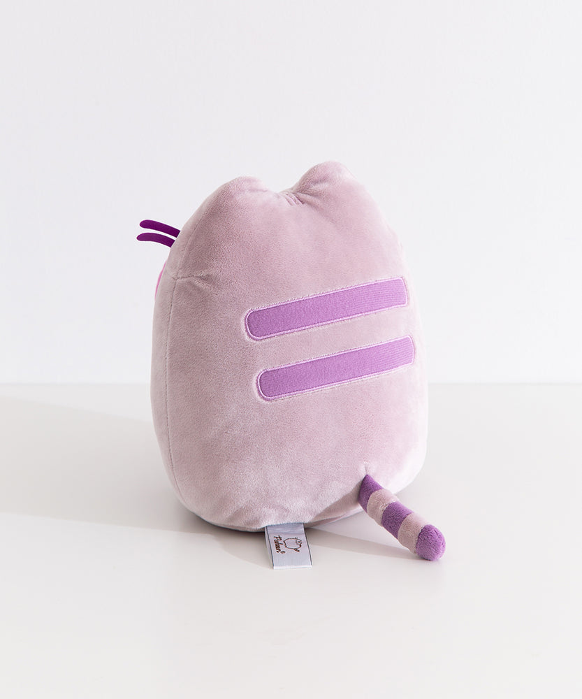 Back quarter view of the Pusheen gaming plush. Pusheen's two back stripes are embroidered in a medium purple color. Pusheen's gray and purple striped tail extends off the back bottom of the plush.