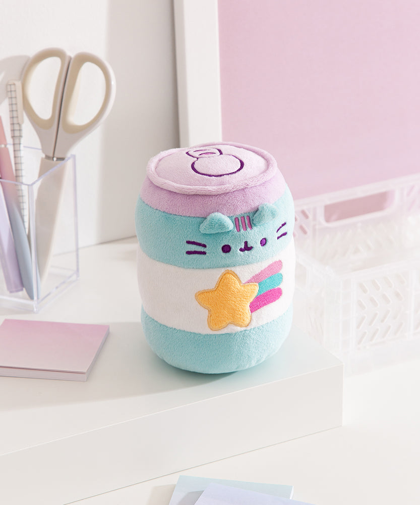 Energy drink plush has a shooting star graphic on the front with a yellow five-pointed star and purple, blue, and pink bursts coming off the right side of the star.
