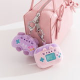 Gaming controller and switch case keychain plush are attached to zippers using their lobster claw clips affixed to the top of the plush.