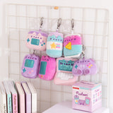 Gamer Surprise Plush hang on a wire rack. The seven miniature plush hang in two rows and the blind box packaging sits below the gamer inspired plush keychains. 