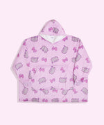 Gamer Pusheen Wearable Blanket Hoodie lies on a light surface. The oversized pullover has a hood, oversized sleeves, a large front pocket, and an all-over-print Pusheen the Cat with pink gaming controllers.