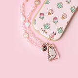 Beaded phone charm is attached to the intended slot in the bottom right corner of the back of the Pusheen phone case. 