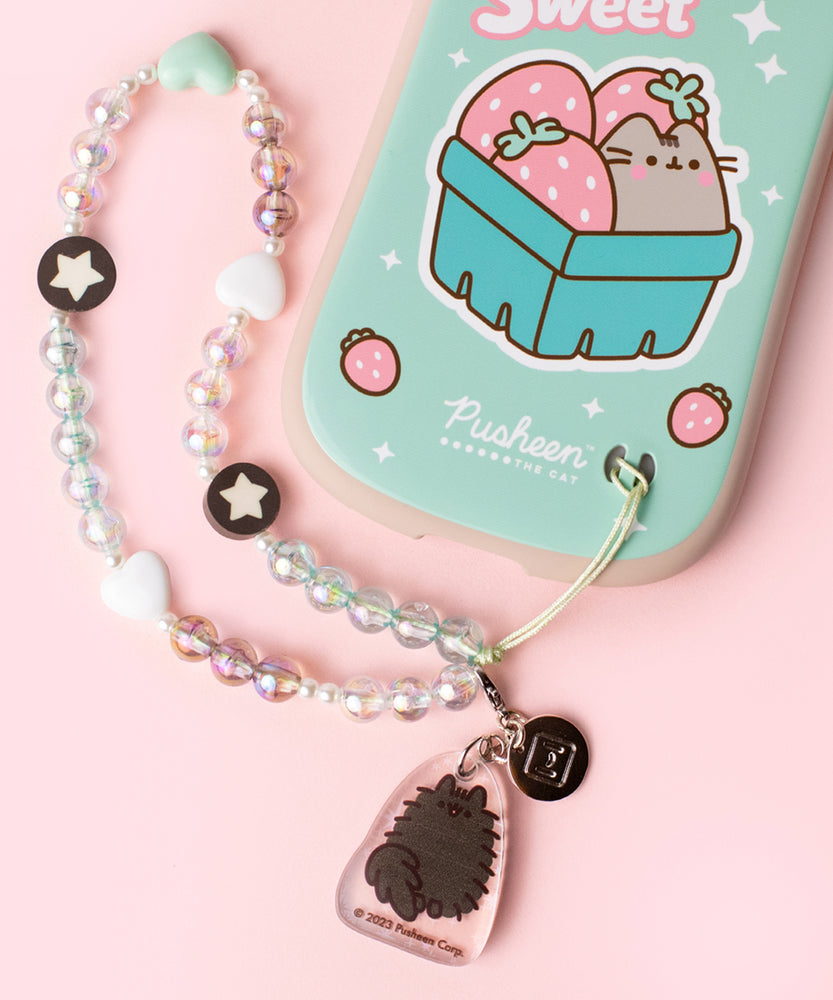 Beaded phone charm is attached to the intended slot in the bottom right corner of the back of the Pusheen phone case.