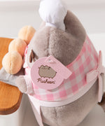 Close-up view of light pink Pusheen logo tag and embossed Pusheen Label tag. 