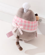 Back view of the Pink Biscuit Baker Pusheen Plush. The checkered top and apron combo are tied in the back with a bow. Pusheen’s gray striped tail is seen coming off the bottom back of the plush. 