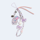 Full view of the beaded phone charm. The long string has a mix of sizes and shapes of silver, white, purple, pink, and blue beads. 