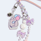 Close-up of the acrylic pastel removable charm on the Pusheen 15th Anniversary Beaded Phone Charm. The charm depicts a pastel-hued Pusheen the Cat holding blue, pink, and purple balloons. 