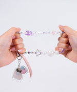 Model shows the strength of the beaded string on the cute purple phone charm. 