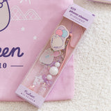 Beaded Phone Charm within purple packaging. The light and dark purple  and white paper has "beaded phone charm" on the topfront and the Pusheen 15 Years logo on the bottom front.