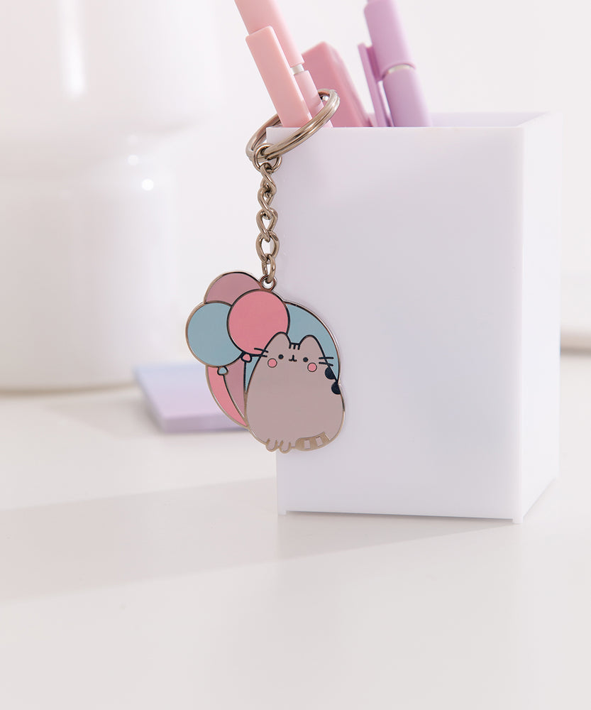Pusheen keychain shows the cat sitting upright with her two front paws and striped tail. 