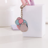 Pusheen keychain shows the cat sitting upright with her two front paws and striped tail. 