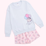 Pusheen 15th Anniversary Pajama Set includes a light blue sweater with a Pusheen graphic and a patterned pair of pink shorts. 