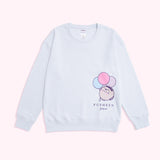 Lying on a background, the Pusheen Pajama Sweatshirt is shown in full. The relaxed-fit light blue sweatshirt gray tee has a printed graphic of Pusheen on the wearer's left side. 