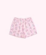Lying on a background, the Pusheen Pajama Shorts are shown in full. The light pink shorts have an elastic waistband and an all over print of Pusheen the Cat.