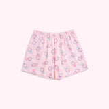 Lying on a background, the Pusheen Pajama Shorts are shown in full. The light pink shorts have an elastic waistband and an all over print of Pusheen the Cat.
