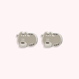Front view of the Pusheen Coffee Stud Earrings. The silver-outlined tabby cat lies behind a steaming cup of coffee. 