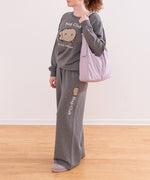 Modeal wearing a gray Pusheen Nap Club Loungewear Set. The matching set includes a sweatshirt and a wide-leg sweat pant.