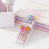 Pusheen Sweets 4-Pen Set in its resealable packaging bag. The pink and clear bag includes a graphic of Pusheen as four multi-colored macarons in a box with a bow.