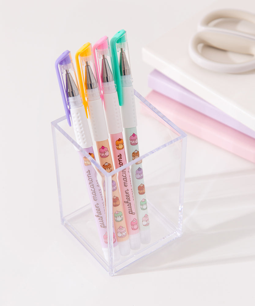 Four Pusheen pens in a clear acrylic pen holder. The pens have matching colored clear caps. 