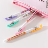 Pusheen Pen Set coming out of the Sweets Pencil Case. The phrase printed among the macaron graphics on the pen barrels says "pusheen macarons" and "sweet every day."