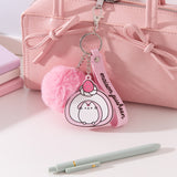 Chunky Pusheen Keychain attached to a pink purse. Pusheen the Cat is transformed inot a pink and white swiss roll topped with a pink and white strawberry and a white whipped cream dollop.