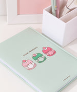 Back cover of the mint green notebook featuring Pusheen as multi-flavored macarons. Above the macarons graphic is the phrase "sweet moments" in brown text.