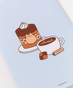 Back of the notebook in the Pusheen Sweets Stationery Set. The light blue notebook has a graphic of Pusheen fitted inside a tiered-mono chocolate cake. Next to the chocolate cake on a plate is a latte with the phrase "sweet."