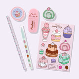 Close-up view of the contents of the Pusheen Sweets Stationery set. The pencil, pen, stickers, eraser, pencil sharpener, and highlighter include graphics and prints of Pusheen the Cat as various sweet dessert characters and flavors including a strawberry, lavender, chocolate, matcha, vanilla, and cherry.