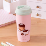 Alternate view of the coffee travel mug. The other large graphic includes Pusheen the Cat inside a sprinkle-tiered chocolate cake with a mocha latte next to the cake. 