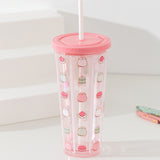 Front view of the Pusheen Sweets Tumbler. The clear beaker has a repeating vertical print all over the clear base. The repeating pattern shows a sitting Pusheen in pink, white, and green with pastry-themed icons.
