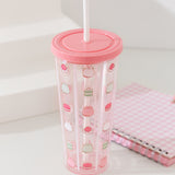 Full view of the sweets-themed water bottle with straw. The icons on the bottle include a whipped cream pile with a pink strawberry, a strawberry macaron, and a mini-tiered matcha-flavored cake.