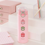 Back view of the Sweets Water Bottle. Descending down the pink bottle are three graphics of Pusheen transformed into macarons. The flavors featured are vanilla, matcha, and strawberry.