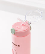 Pink pusheen water bottle is a vertical graphic down the center back of the Sweets Water Bottle. Pusheen transforms into light pink, white, green, and medium pink macarons. 