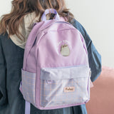 Model carries the Pusheen Backpack on shoulder to show size and scale of the purple backpack.