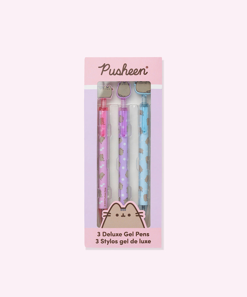Pusheen Deluxe Gel 3-Pen Set in its packaging box. The pink and purple box includes the Pusheen logo and a graphic of the cat's face at the bottom above the product title "3 Deluxe Gel Pens."